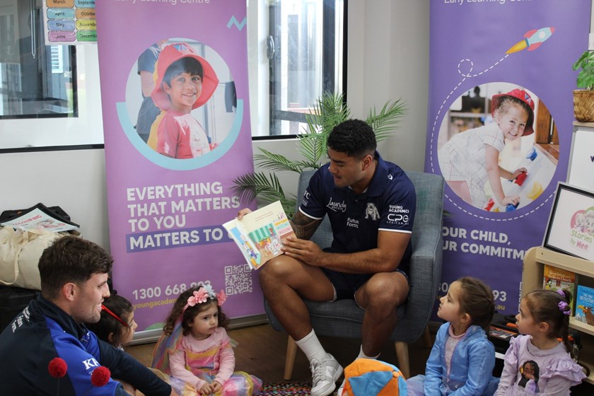 Toby Sexton and Jeral Skelton sharing the joys of reading with Young Academics children.